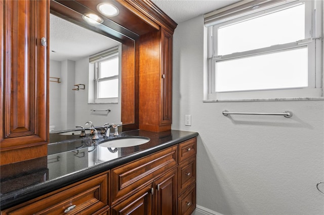 bathroom with vanity and a textured ceiling