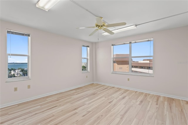 unfurnished room with ceiling fan and light hardwood / wood-style floors