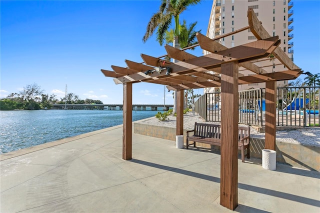 view of home's community featuring a pergola, a playground, and a water view