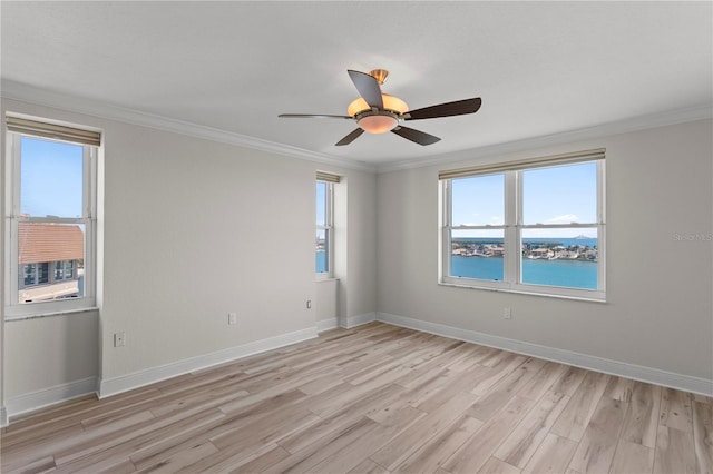 unfurnished room with a water view, light hardwood / wood-style flooring, ceiling fan, and ornamental molding