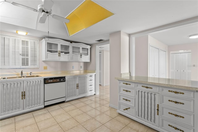 kitchen featuring white cabinets, ceiling fan, sink, light tile patterned floors, and dishwasher