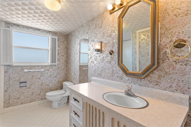 bathroom featuring tile patterned floors, vanity, and toilet