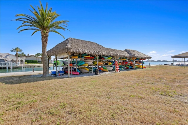 exterior space with a lawn, a gazebo, and a water view