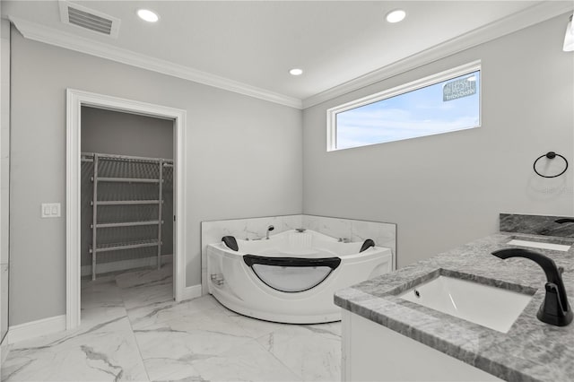 bathroom with crown molding, a tub to relax in, and vanity