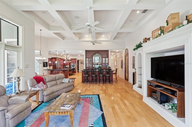 living room with coffered ceiling, ceiling fan with notable chandelier, crown molding, beam ceiling, and hardwood / wood-style floors