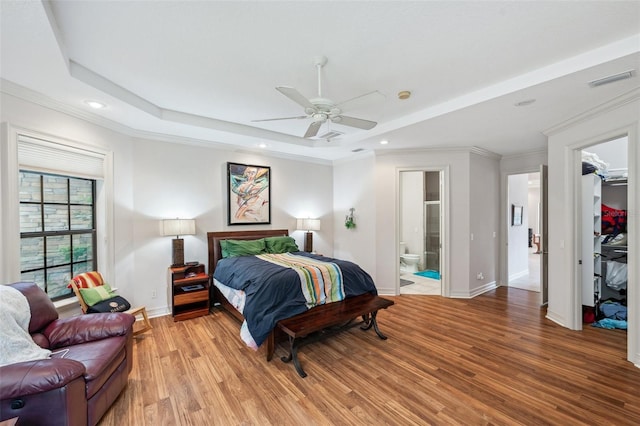 bedroom with a walk in closet, ceiling fan, light hardwood / wood-style flooring, connected bathroom, and a closet