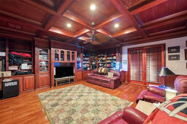 living room featuring beamed ceiling, ornamental molding, and light hardwood / wood-style flooring