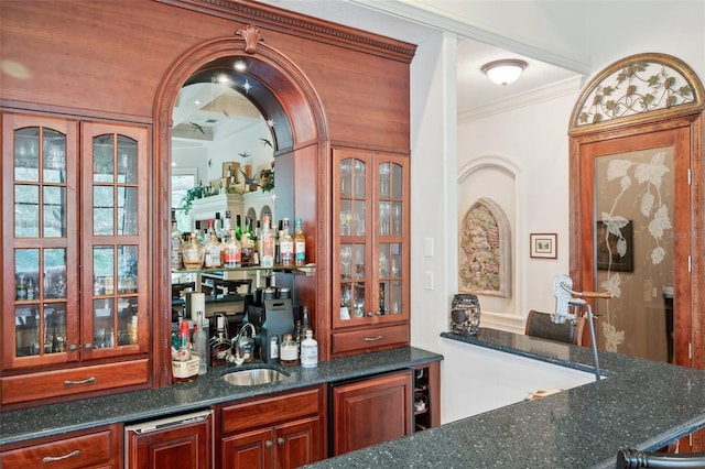 bar with crown molding, sink, and dark stone counters