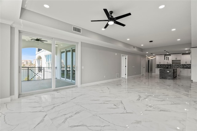 unfurnished living room with ceiling fan