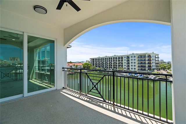 balcony with a water view and ceiling fan