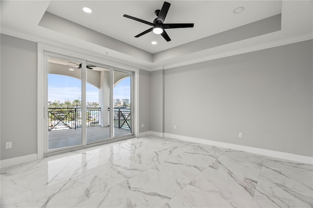 unfurnished room with crown molding, a tray ceiling, and ceiling fan