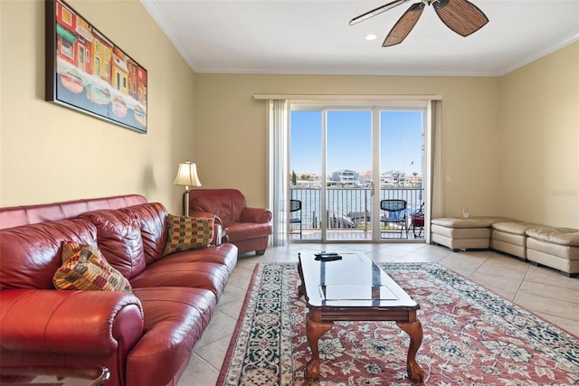 living room with light tile floors, ceiling fan, and ornamental molding