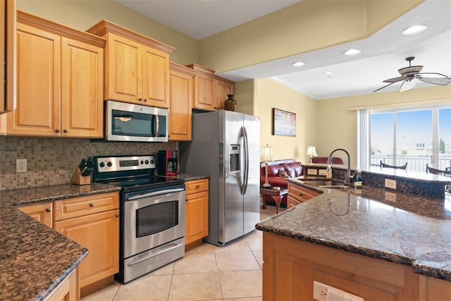 kitchen featuring ceiling fan, sink, backsplash, stainless steel appliances, and light tile flooring