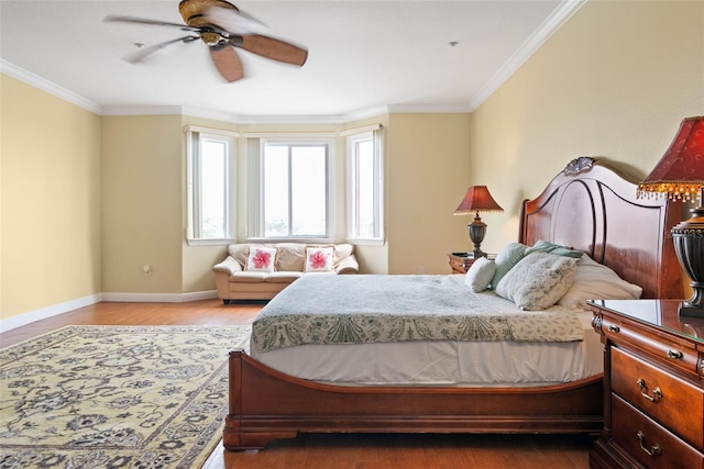 bedroom featuring crown molding, dark hardwood / wood-style floors, and ceiling fan