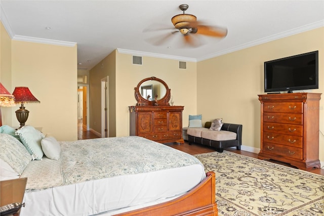 bedroom with ornamental molding, ceiling fan, and dark wood-type flooring