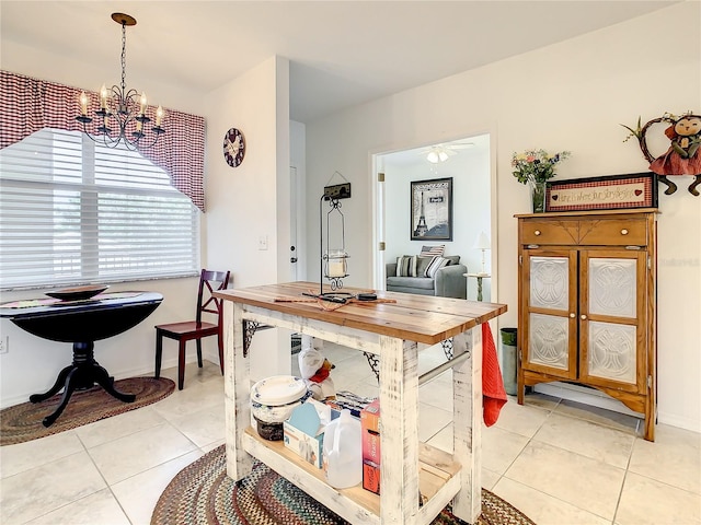 tiled dining room featuring an inviting chandelier