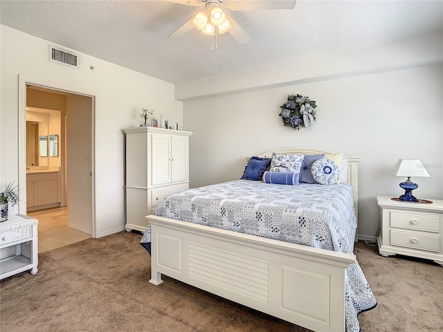 carpeted bedroom featuring ensuite bathroom and ceiling fan