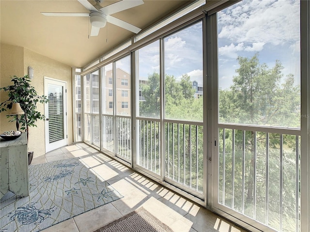 sunroom / solarium featuring ceiling fan