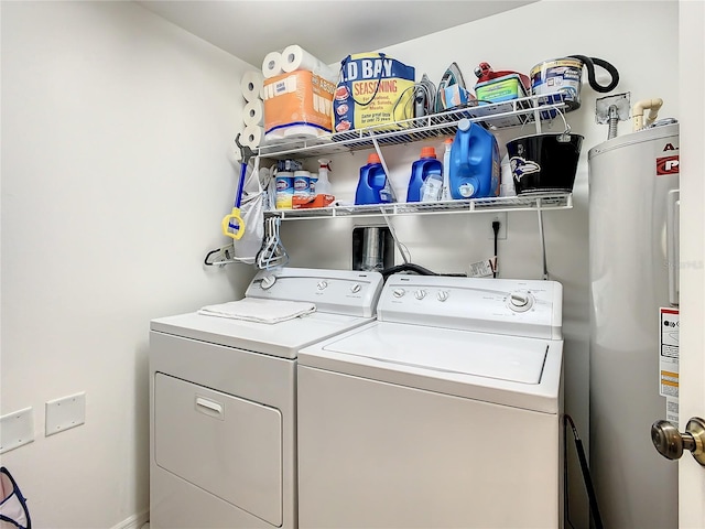 clothes washing area with electric water heater and washer and clothes dryer