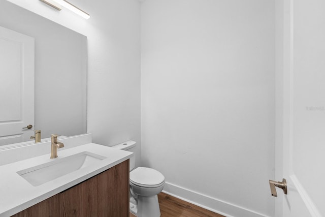 bathroom featuring hardwood / wood-style floors, vanity, and toilet