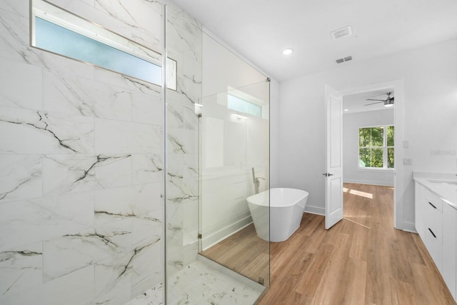 bathroom with ceiling fan, vanity, independent shower and bath, and hardwood / wood-style flooring