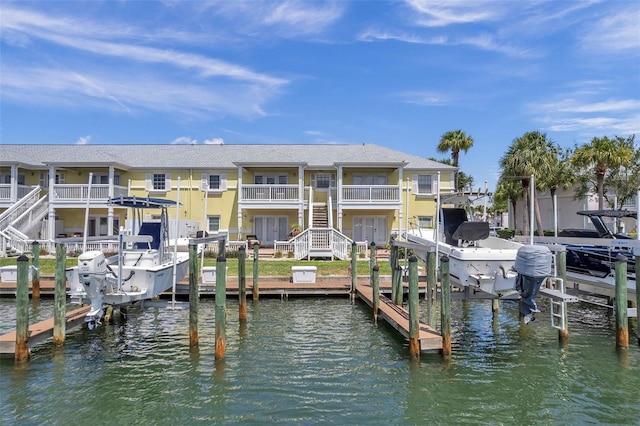 dock area with a balcony and a water view