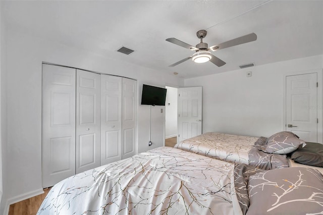 bedroom with a closet, ceiling fan, and light wood-type flooring