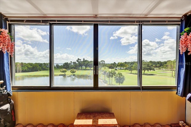 sunroom / solarium featuring a water view