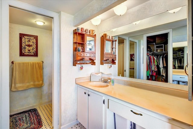 bathroom with tile flooring and vanity with extensive cabinet space