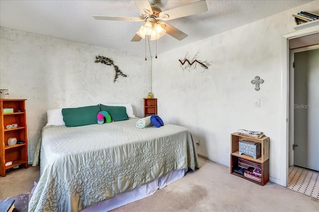 carpeted bedroom featuring ceiling fan and a textured ceiling