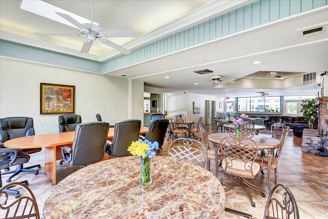 dining area featuring light tile floors and ceiling fan