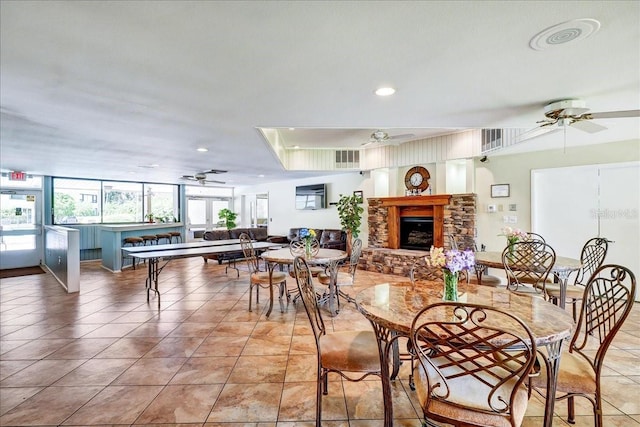 dining space featuring light tile floors and ceiling fan