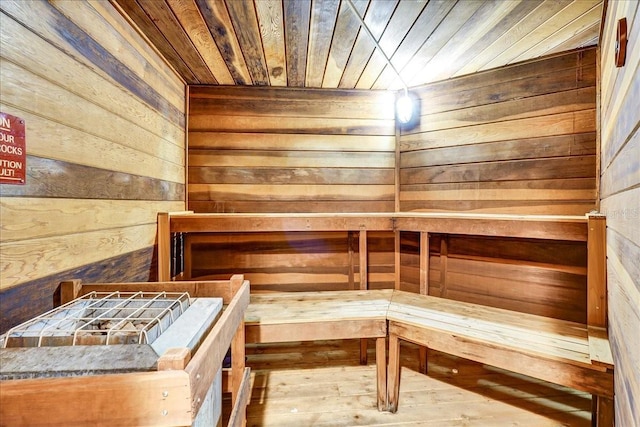 view of sauna / steam room with wooden walls, hardwood / wood-style floors, and wooden ceiling