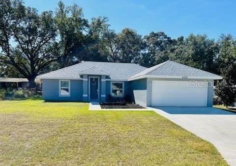 ranch-style home featuring a front yard and a garage