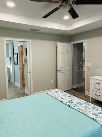 unfurnished bedroom with ceiling fan and dark hardwood / wood-style flooring