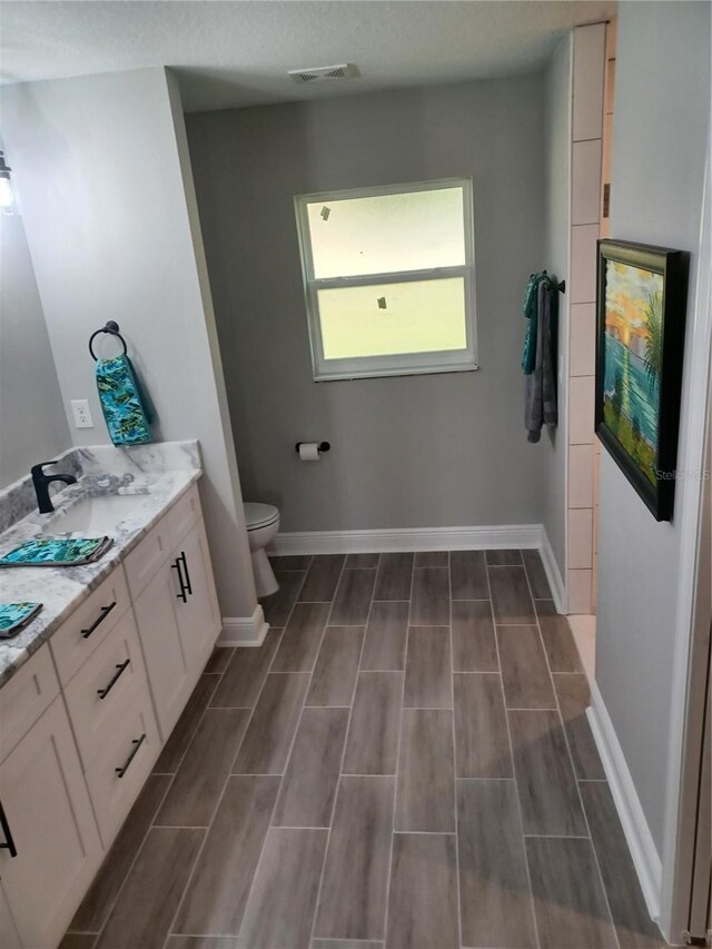 bathroom featuring vanity and toilet