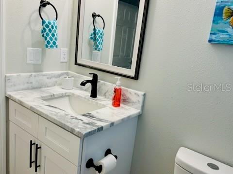 bathroom featuring vanity and toilet