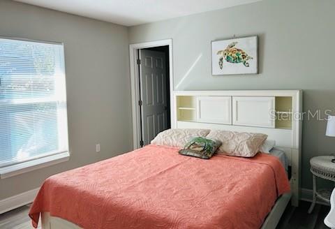 bedroom with hardwood / wood-style flooring