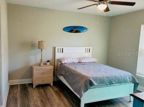 bedroom with ceiling fan and dark hardwood / wood-style flooring