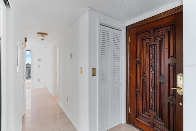 hall with a textured ceiling