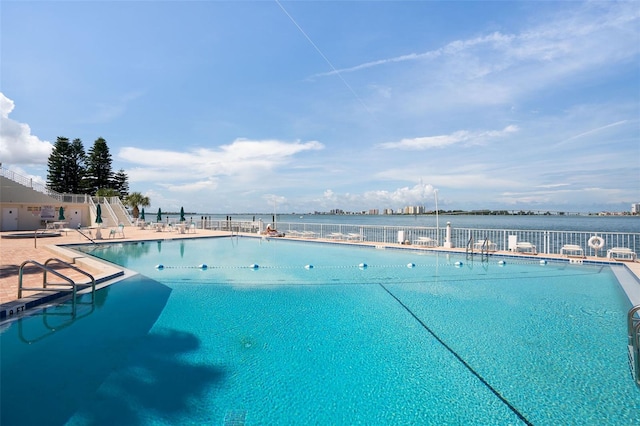 view of swimming pool featuring a water view