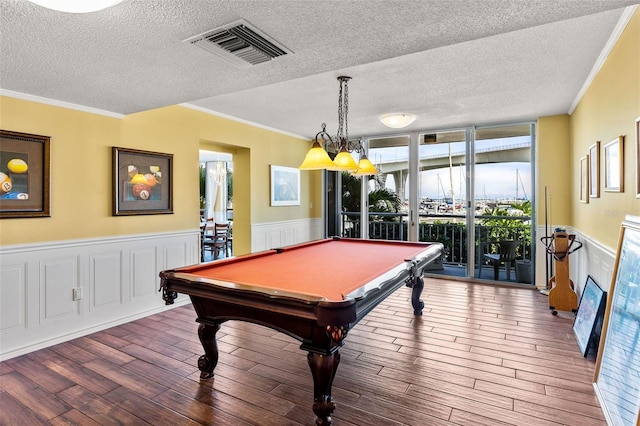 recreation room with crown molding, dark wood-type flooring, billiards, and a healthy amount of sunlight