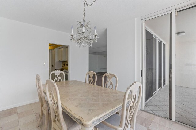 tiled dining area with an inviting chandelier