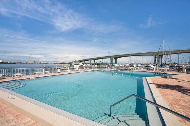 view of swimming pool featuring a water view