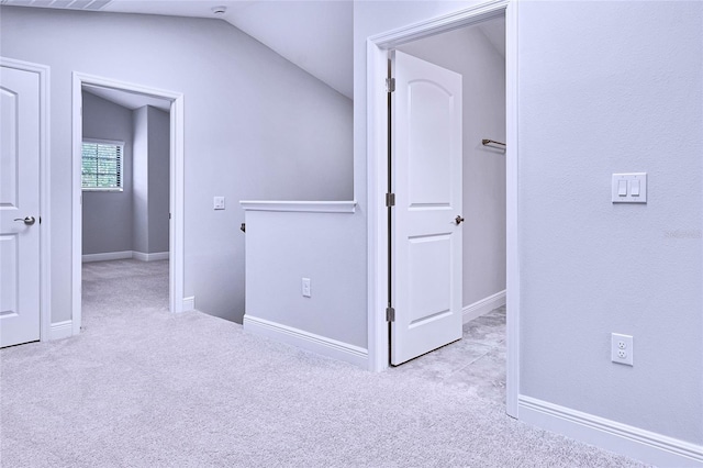 interior space with light colored carpet and lofted ceiling