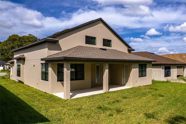 back of house featuring a patio and a lawn