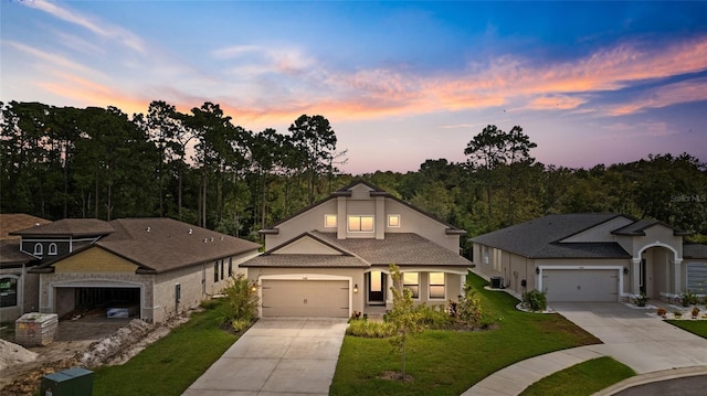 view of front of home featuring a lawn and a garage