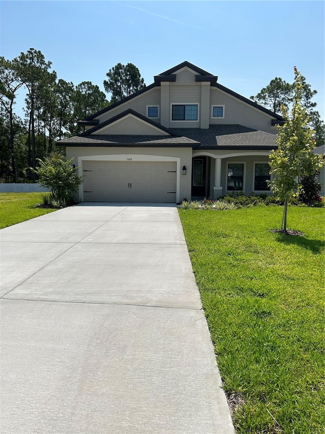 view of front of home featuring a front yard and a garage