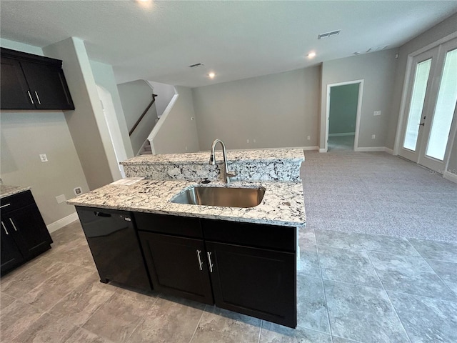 kitchen featuring light stone counters, dishwasher, an island with sink, french doors, and sink