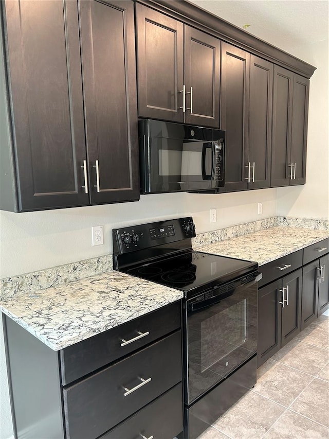 kitchen featuring light tile patterned flooring, black appliances, light stone counters, and dark brown cabinetry